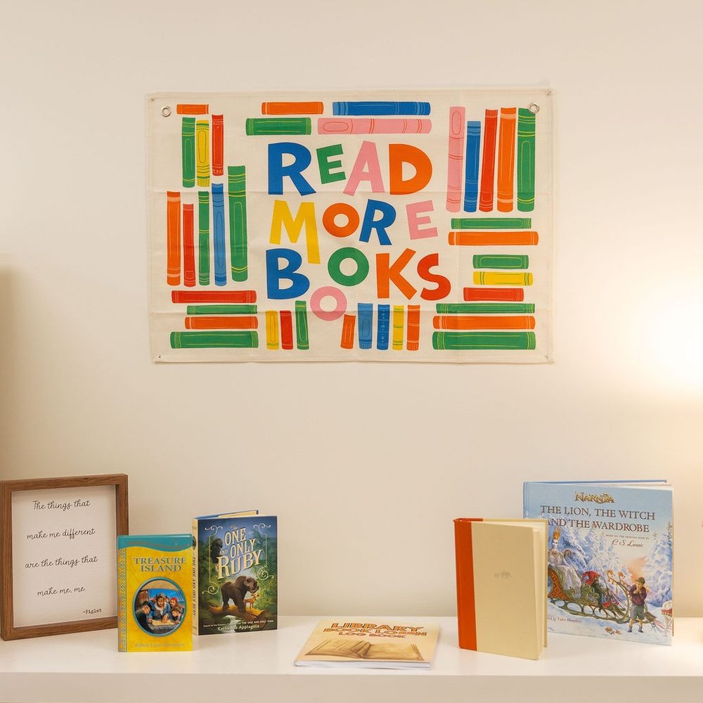 A Read More Books print above the classroom library shelves