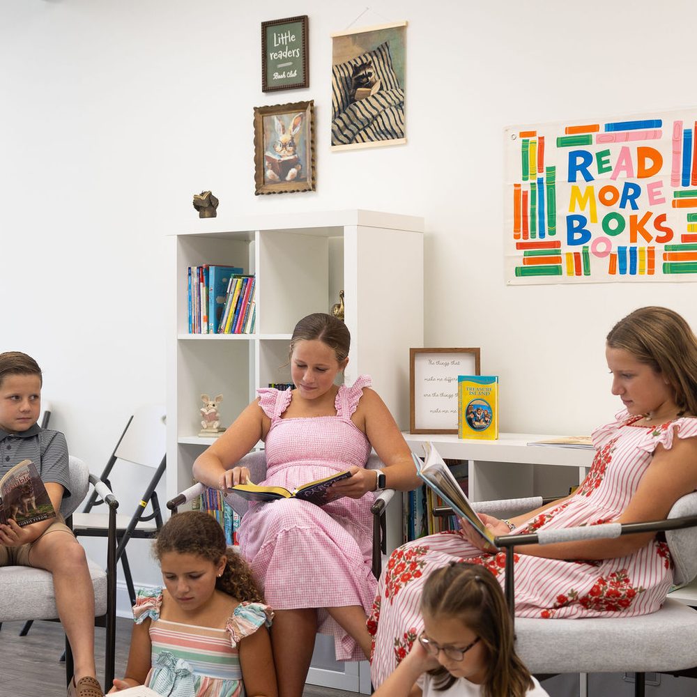 Children reading together in the book nook at Cupertino Academy